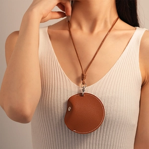 Maillard style brown round leather mini storage bag necklace with woven strap for women