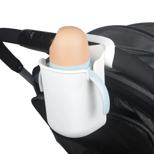 Close-up of white universal stroller cup holder with orange baby bottle inside