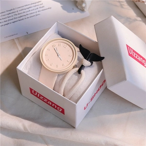 Minimalist cream watch and woven whale tail bracelet set in a gift box with embossed dial