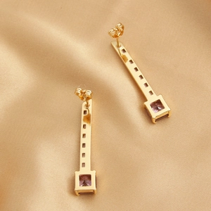Elegant 18k gold plated key dangle earrings with purple zircon stones on silk