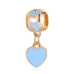 Close-up of rose gold charm with blue enamel flower and hanging heart pendant