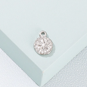 Minimalist silver star and dot pattern stainless steel pendant necklace on blue stand