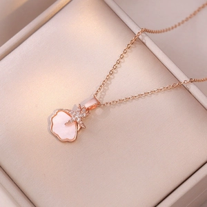 Close-up of rose gold necklace with pink shell and starfish pendant in a jewelry box