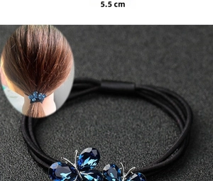 Détail de l'élastique à cheveux papillon en cristal bleu avec marquage de 3,5 cm