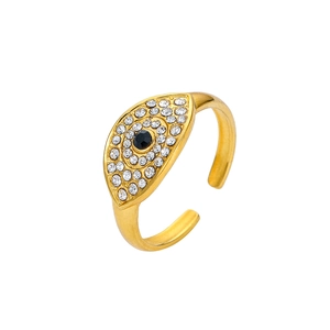 Detailed macro view of an adjustable golden evil eye ring with sparkling zircon pavé