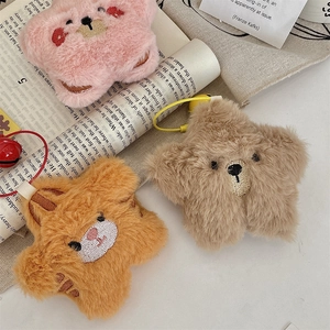Detailed close-up of fluffy star plush keychains in pink, brown, and orange colors