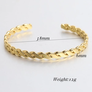 Detailed view of golden twisted C-shape cuff bracelet with 58mm inner diameter and 6mm width