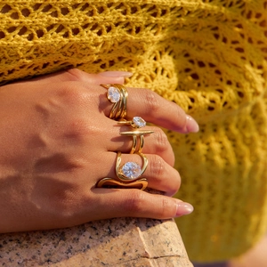Elegant gold-plated stainless steel ring set with zircon stones worn by a model