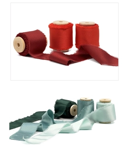 Frayed edge chiffon ribbons in multiple colors wound on vintage wooden spools