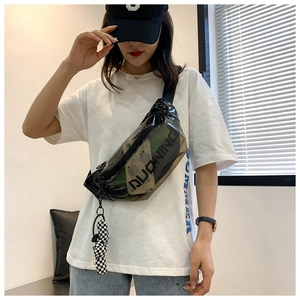 Detailed view of black transparent PVC crossbody chest bag with checkered charm and logo