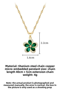 Macro detail of a 2.2cm flower pendant with green stones and white micro-inlaid crystals