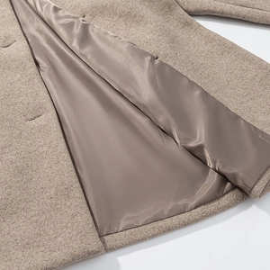 Macro view showing the high-quality lining and durable woolen fabric of the coat