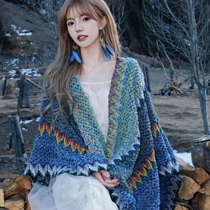 Bohemian blue knitted shawl cape with geometric patterns and fringe for holiday travel wear