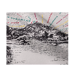 Macro shot of boho tapestry fabric texture with abstract black and white mountain patterns