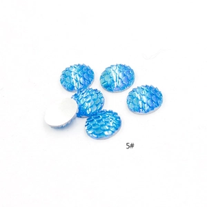 Macro detail of iridized blue fish scale resin cabochons with flat back for DIY