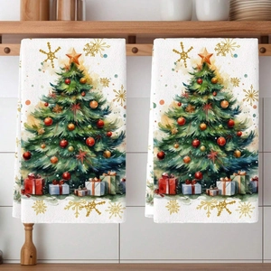 Detail of two Christmas towels with watercolor tree prints hanging in a kitchen