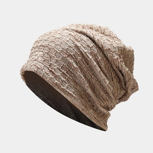 Close-up of the thick knit texture and light brown tie-dye pattern on the slouchy beanie