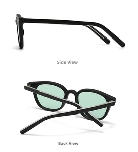 Detail view of black acetate sunglasses with mint green lenses and silver metal core