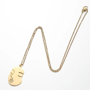 Detail of 18K gold plated abstract face pendant with dual chain and lobster clasp closure