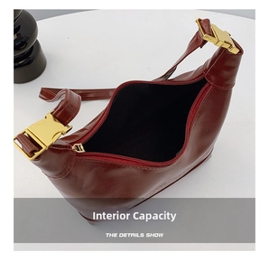 Detail of burgundy leather dumpling bag featuring a golden buckle and spacious inner lining