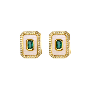 Macro shot of 18K gold plated earring with emerald cut stone and mother of pearl