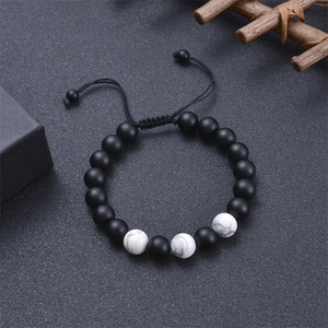 Detail of adjustable tiger eye and lava stone yoga bead bracelet with matte finish