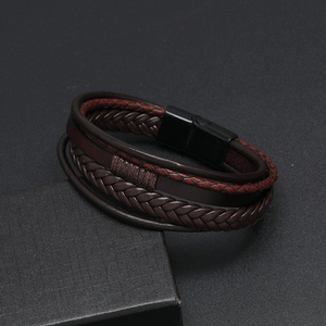 Detailed close-up of multilayer braided leather bracelet with black magnetic clasp