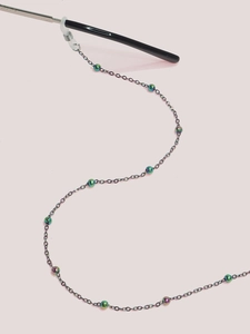 Detailed view of colorful metallic beads on a slender eyeglass chain with silicone loops