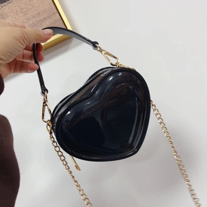 Close-up of black heart jelly bag with glossy finish and gold chain strap handle