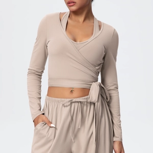 Detail of khaki wrap yoga top and drawstring high-waist joggers in soft knit fabric