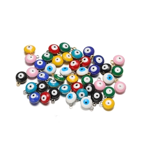 Macro shot of colorful enamel evil eye charms for DIY necklace and earring jewelry making