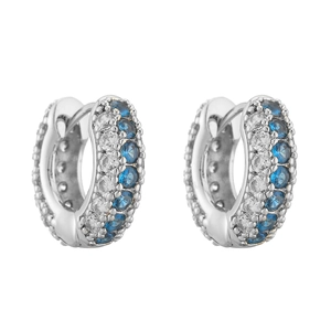 Detailed macro view of silver hoop earrings featuring blue and white micro-pave crystals