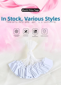 Close-up of bulk white jewelry price tags with strings in rectangular and scalloped shapes