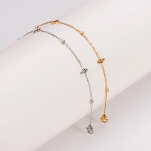Golden and silver stainless steel anklets featuring musical note charms and crystals