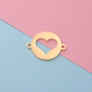 Detailed view of a gold heart cutout round metal pendant connector on pink and blue background