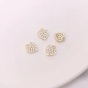 Detailed macro view of 14K gold-plated heart charms with micro-pave cubic zirconia