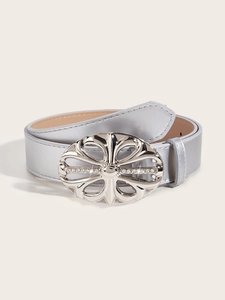 Close-up of a rolled black leather belt featuring a large rhinestone-studded metal buckle
