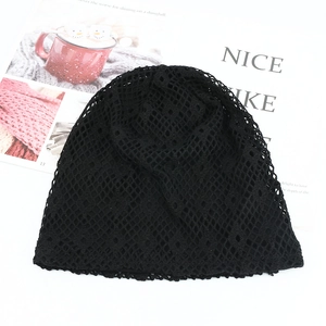 Close-up detail of black hollow knit mesh beanie with breathable diamond pattern texture