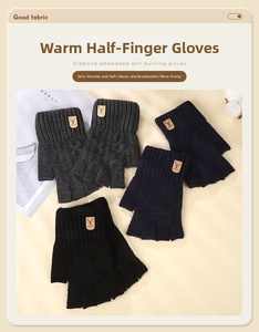 Detail of knitted alpaca wool half-finger gloves with ribbed cuffs and leather deer patch