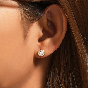 Close-up of classic 925 sterling silver C-shaped gold stud earring worn by model