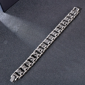 Macro detail of men's vintage dragon link bike chain bracelet in antique stainless steel