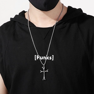 Men's titanium steel cross bone pendant necklace worn by a model in a street style look