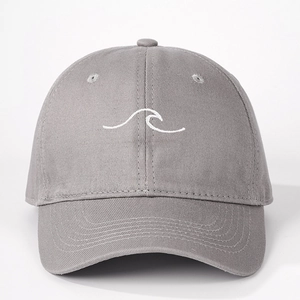 Detailed close-up of white wave embroidery on a gray cotton twill baseball cap