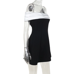 Detail of off-shoulder neckline with white satin contrast on a black bodycon dress