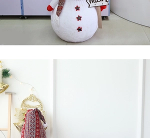 Detail of giant Christmas snowman with Welcome sign, red scarf and star buttons