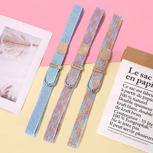 Three elastic woven belts for women with silver metal buckles in pastel colors
