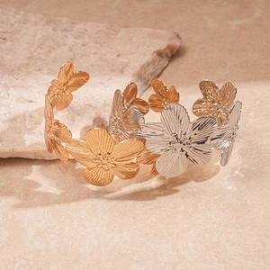 Artistic floral metal cuff bracelet in gold and silver finish with brushed texture