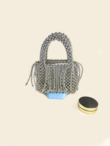 Fashionable silver metallic beaded bucket bag with tassel detail and woven handle