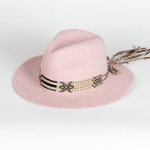 Detail shot of pink straw beach hat with ethnic geometric band and long fringe tassels