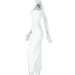 Detail view of the side pleated texture and slim fit on a white halter neck maxi dress